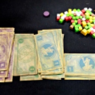 Some nice looking thick paper money and colorful cubes. Only we as gamers can see the beauty in this right?