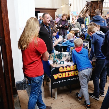 Kids and miniatures are always a success. Lovely little booth from Games Workshop and stellar painting on the miniatures.